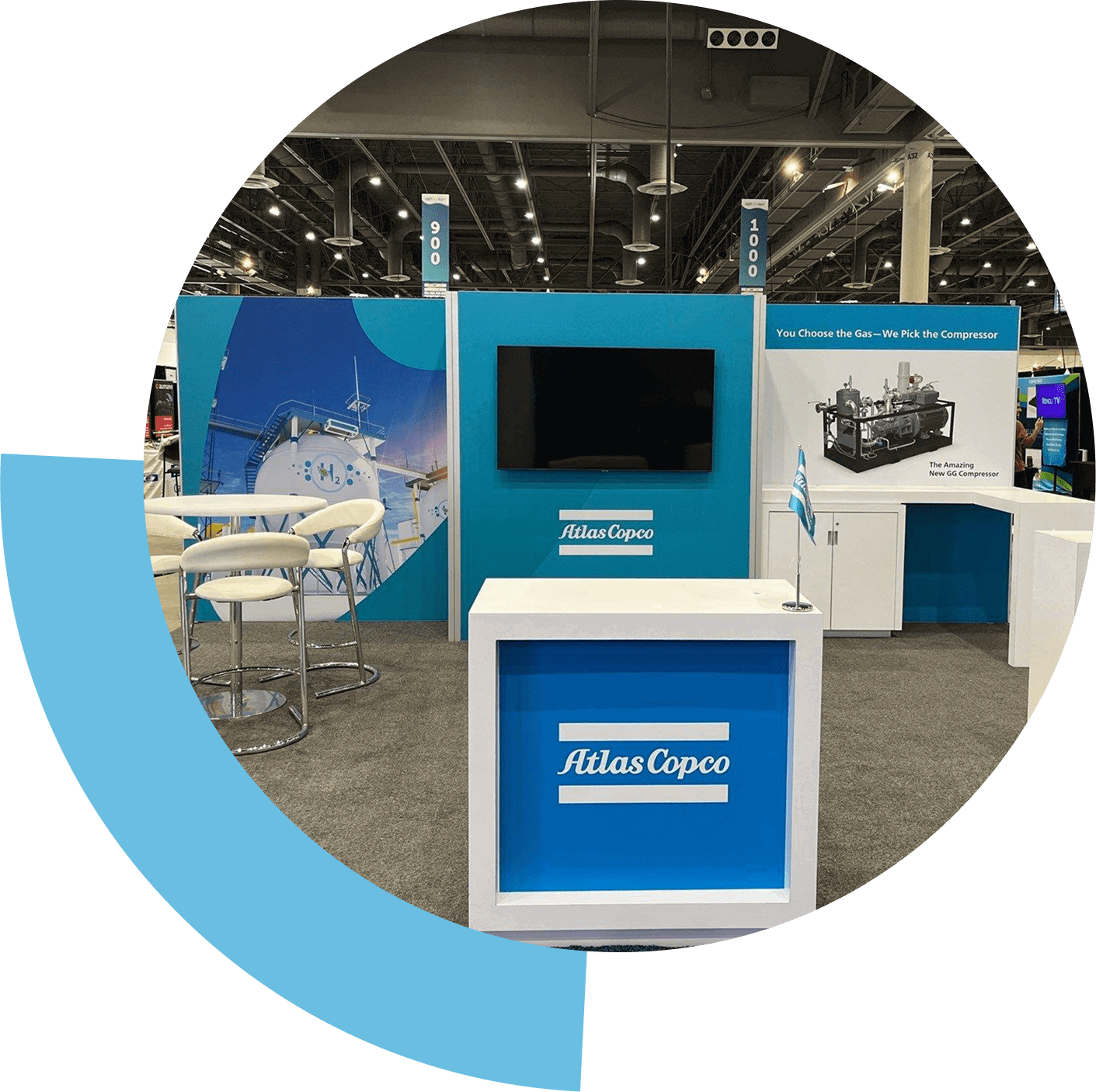 Exhibition booth showcasing Atlas Copco equipment and technology.