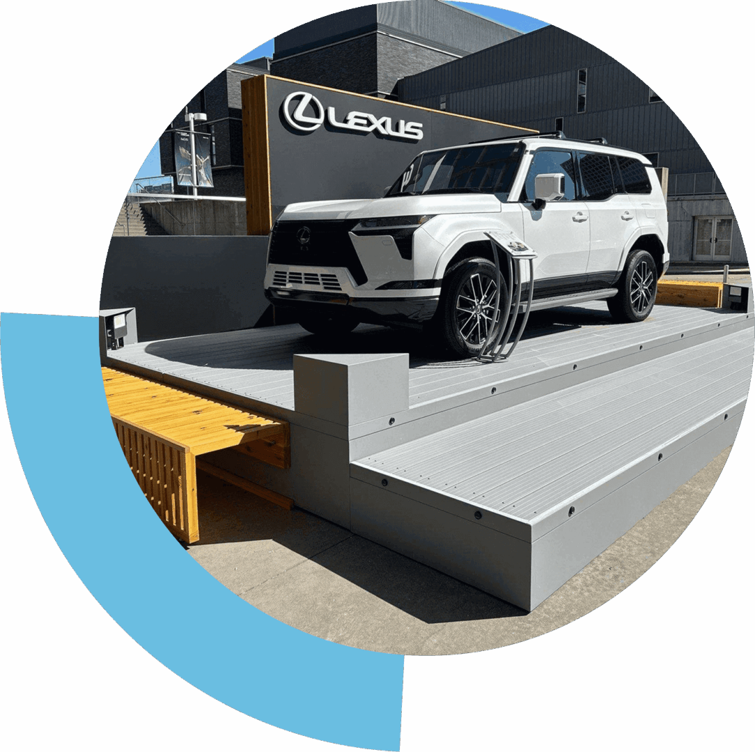 White Lexus SUV displayed on a stepped platform outdoors.
