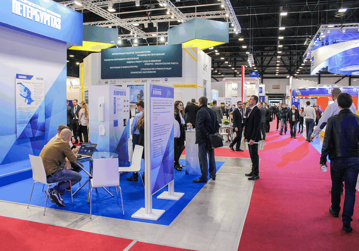 Trade show with people at exhibition booths.